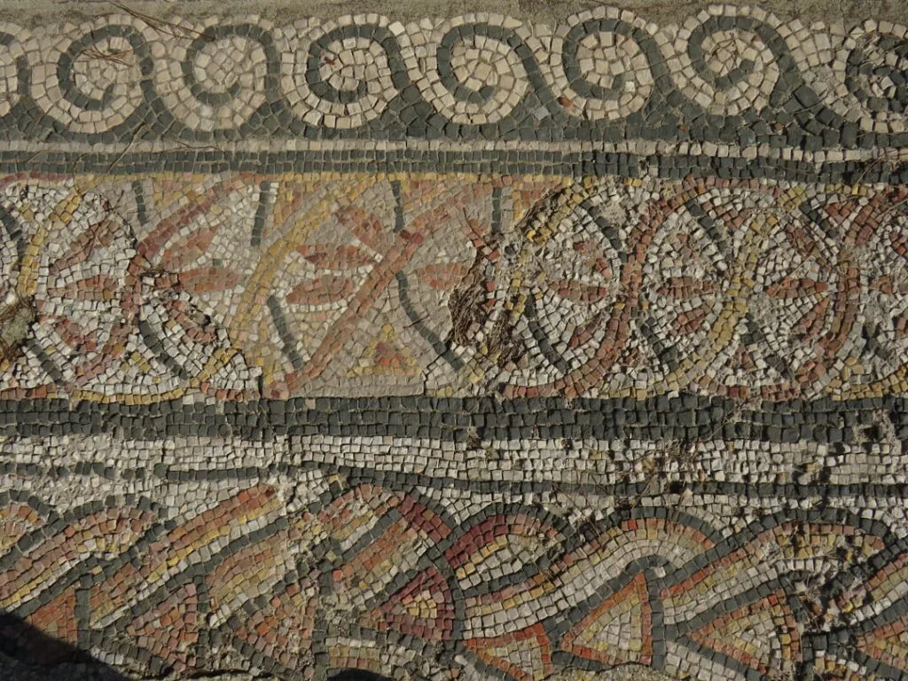 Ancient mosaic floor detail with geometric patterns in Naples