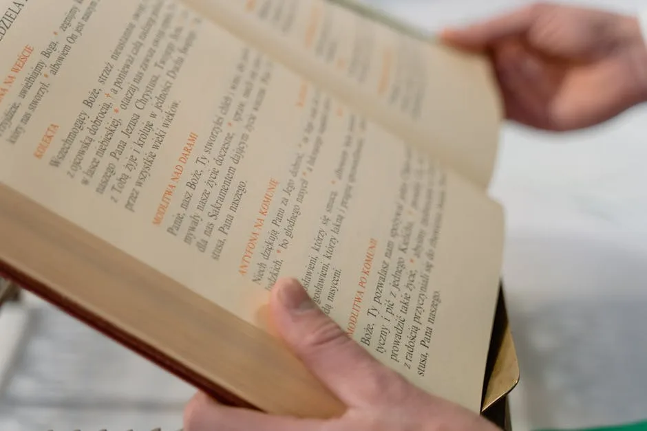 Two hands flipping pages of a guidebook about Naples.