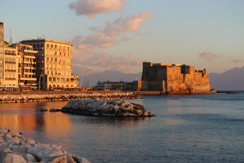 Castel dell'Ovo on the Naples waterfront bathed in warm sunset light