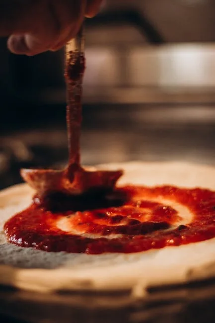Tomato sauce being ladled onto pizza dough in Naples pizzeria.