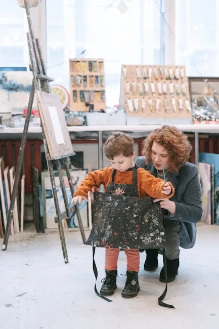 Child wearing paint-splattered apron guided by adult in Naples art studio