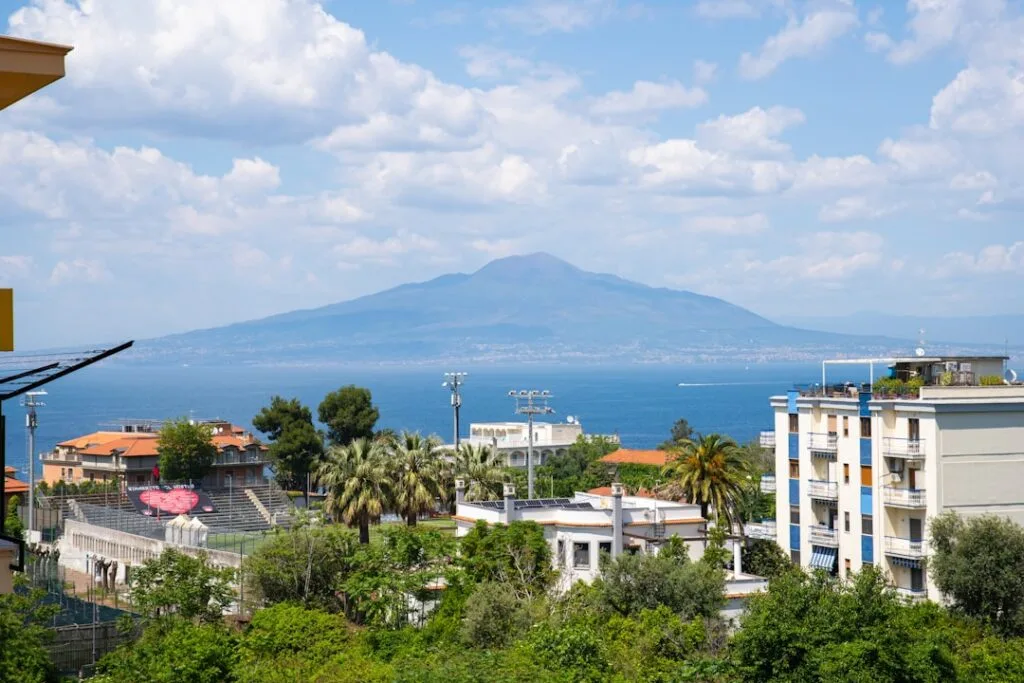 Mount Vesuvius rising across the bay above Naples residential buildings