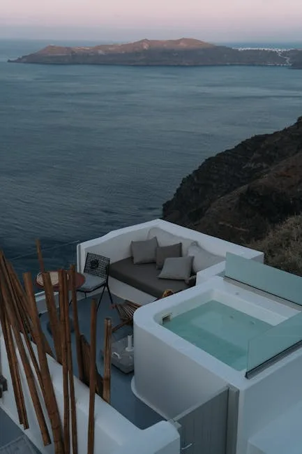 White terrace with private plunge pool overlooking steep coastal cliffs and sea