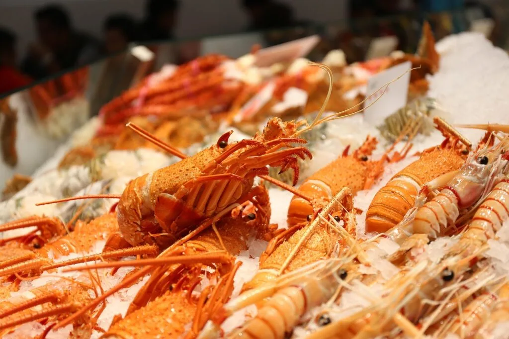 Fresh langoustines on ice at a Naples seafood market counter
