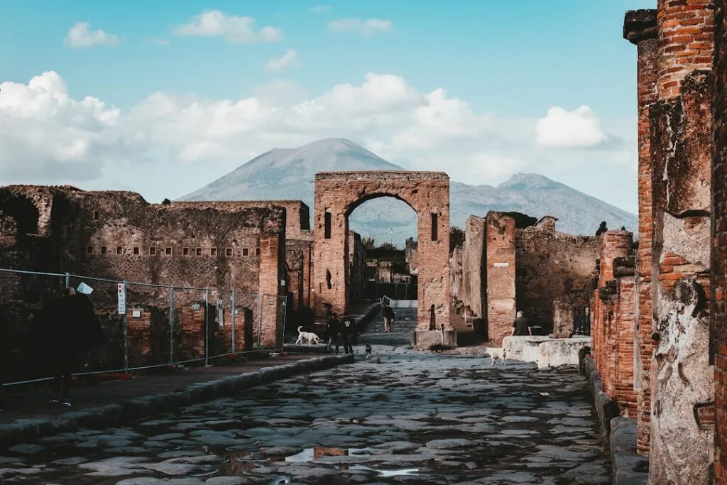 Street musicians and a barrel organ with Vesuvius in the background