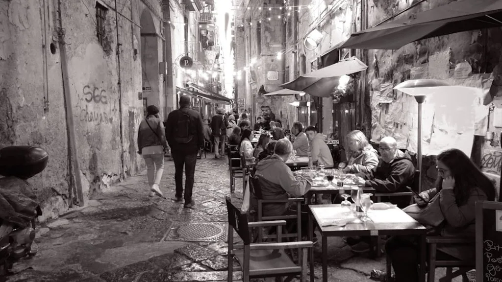 Evening street lights in Naples and a pizza takeaway
