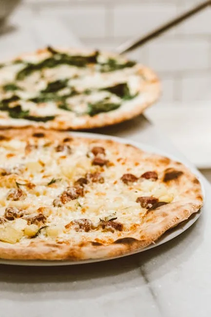 Wood-fired Neapolitan pizza topped with cheese and potatoes in Naples