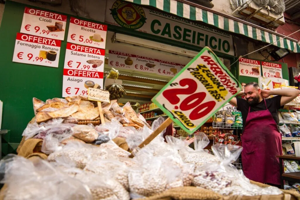 Busy Neapolitan market stall with sacks of beans and vendor
