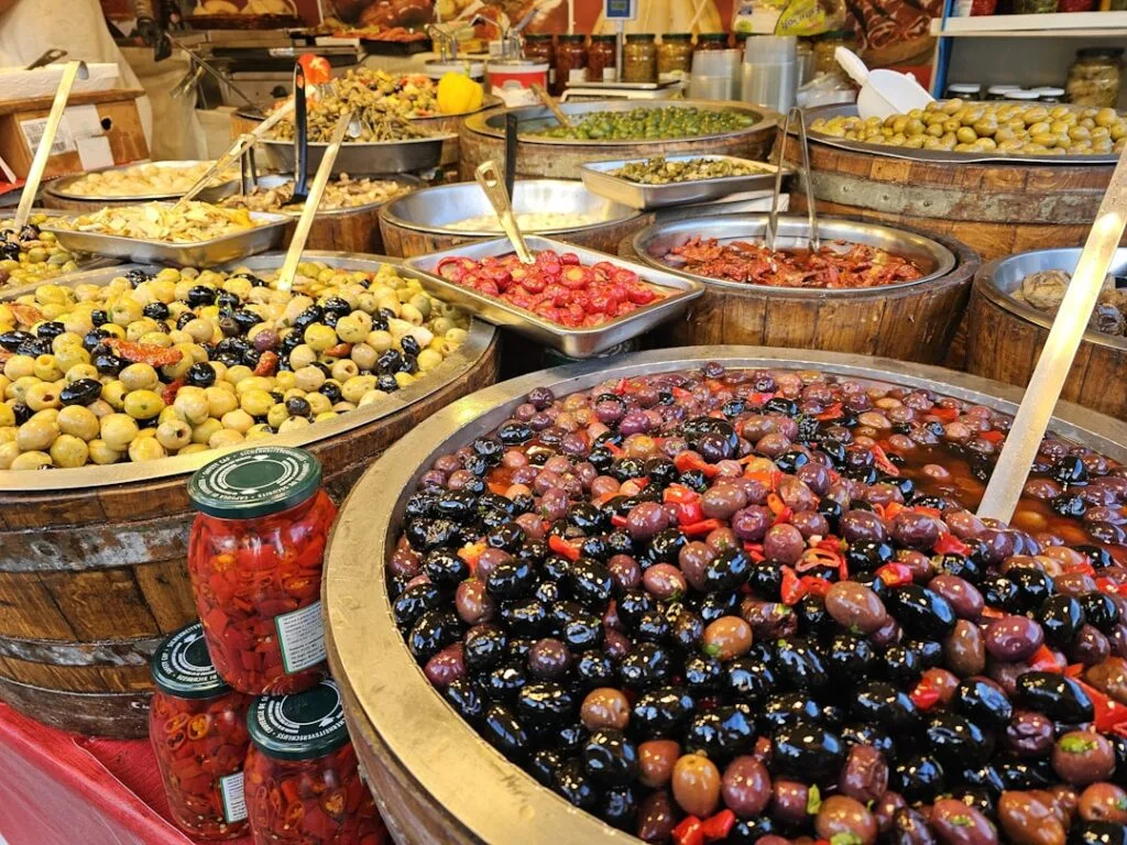 Barrels of marinated olives and antipasti on display at Naples market