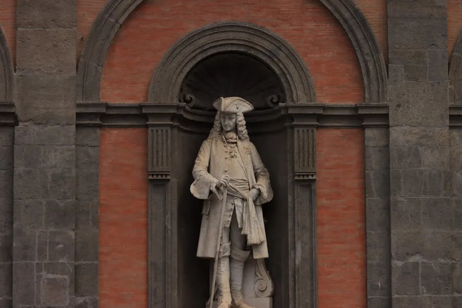 Stone statue of a robed figure in San Carlo facade, Naples