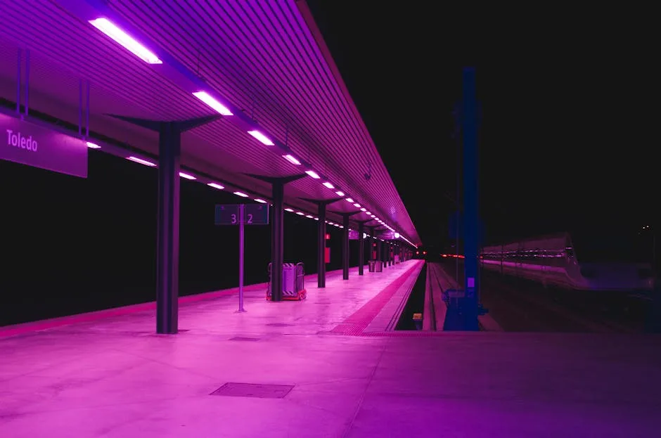 Empty Naples Toledo metro platform lit by magenta lights at night