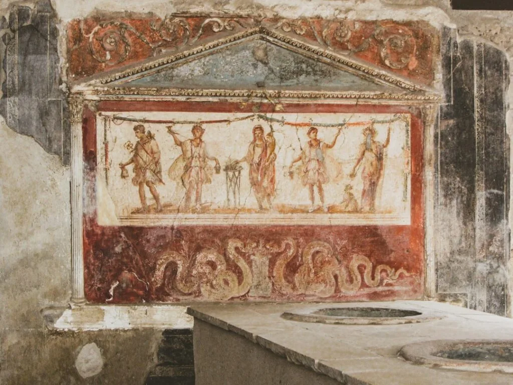Colorful Roman fresco inside a Pompeii house showing mythological figures
