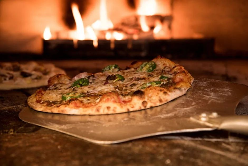 Wood-fired oven pizza sliding on peel with flames in background