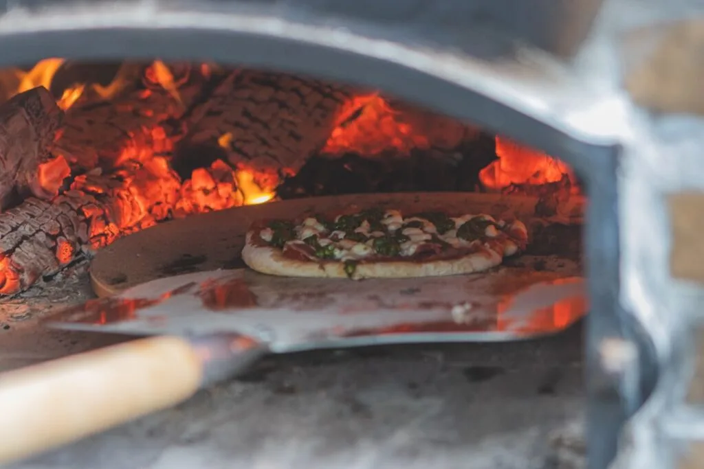 Close-up of wood-fired oven pizza cornicione