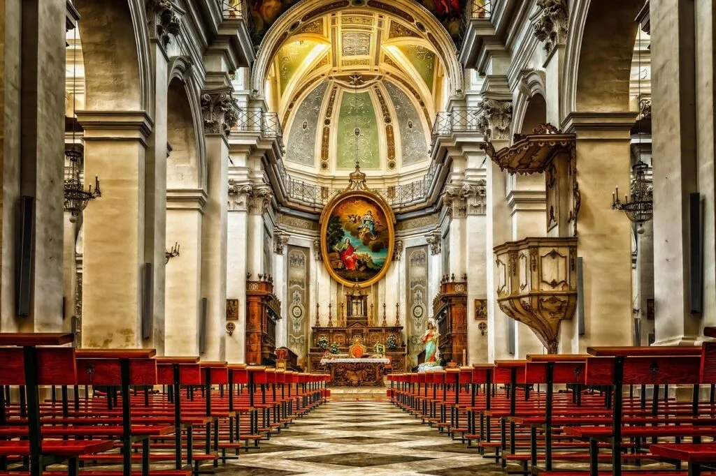 Baroque church interior in Naples with ornate altar and painted dome