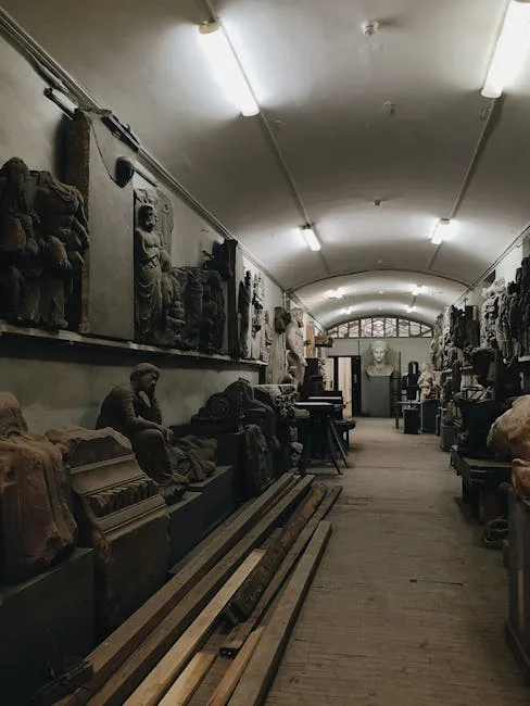 Dim museum storage corridor lined with ancient statues in Naples