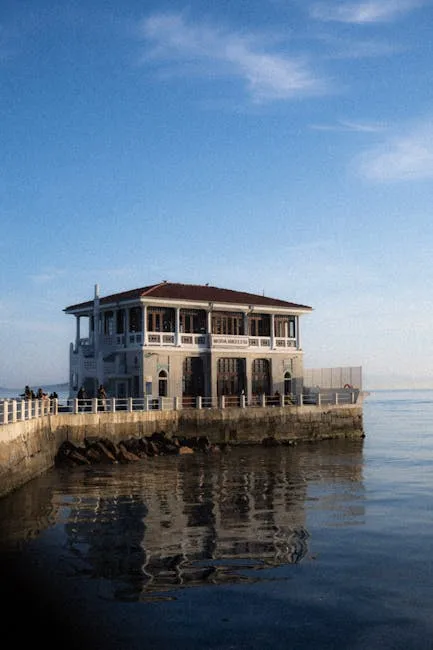 Historic seaside pavilion on Naples pier reflecting in calm water