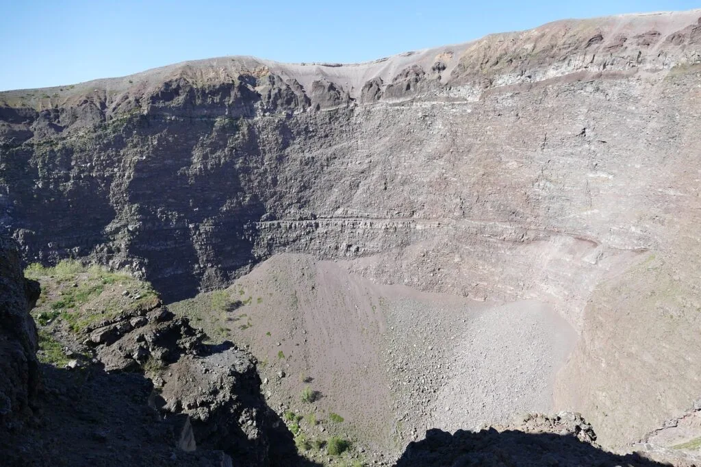 Steep rocky crater interior of Mount Vesuvius under clear sky