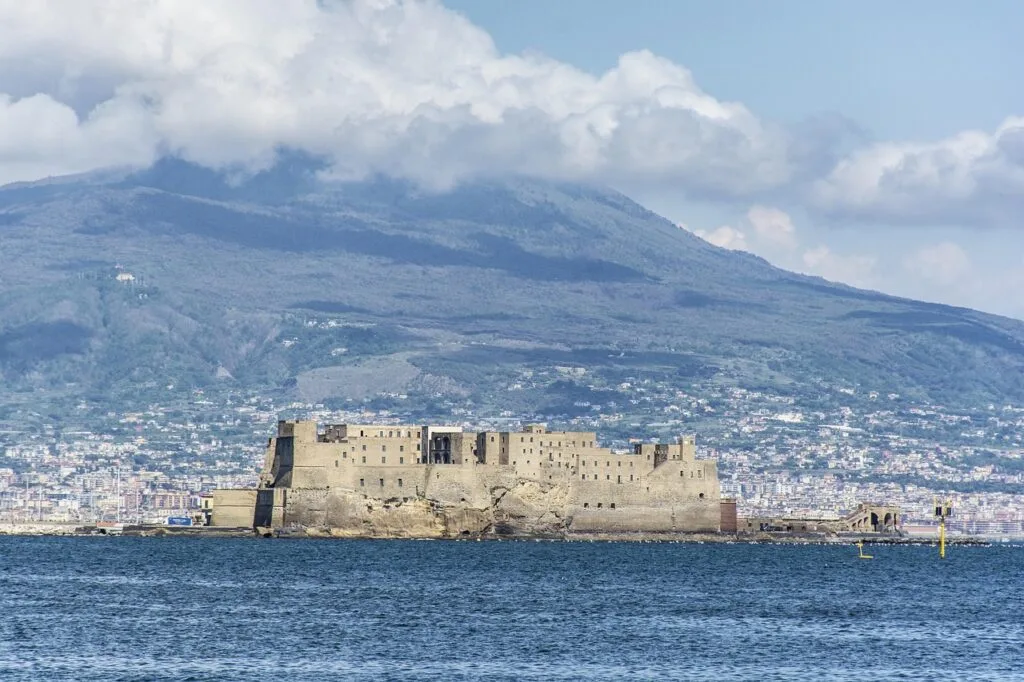Castel dell'Ovo fortress off the Naples coast with Vesuvius behind