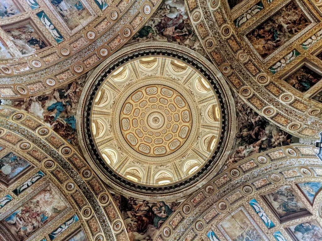 Gilded frescoed dome ceiling inside a Naples baroque church