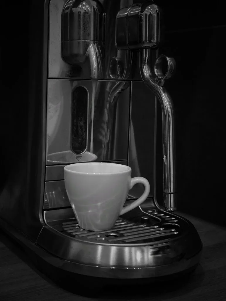 Espresso machine with white cup ready, typical Naples morning ritual